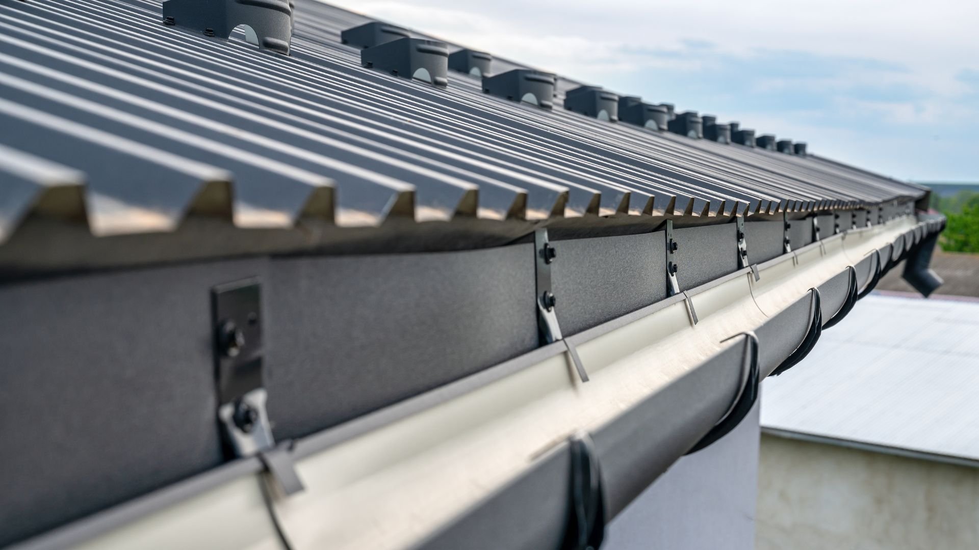Close-up of metal roof with gutters and architectural details