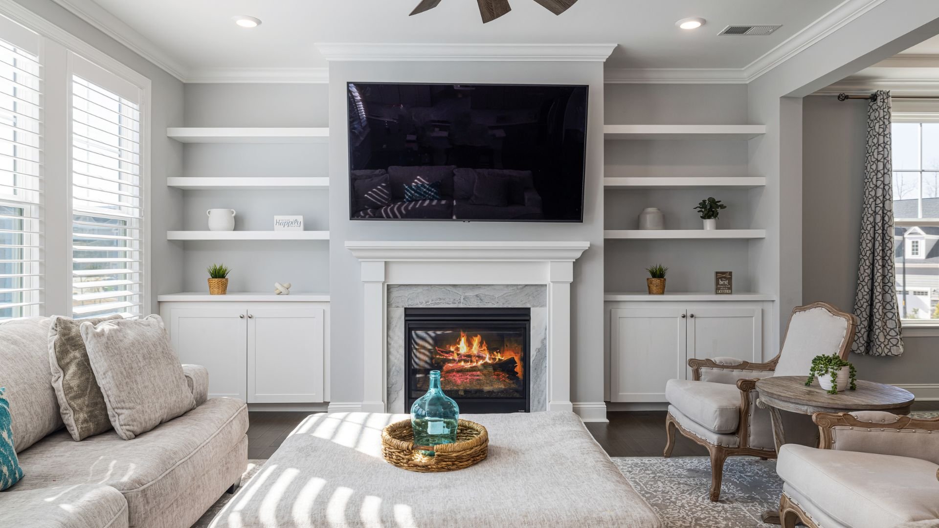 Cozy living room with fireplace, built-in shelves, and large TV