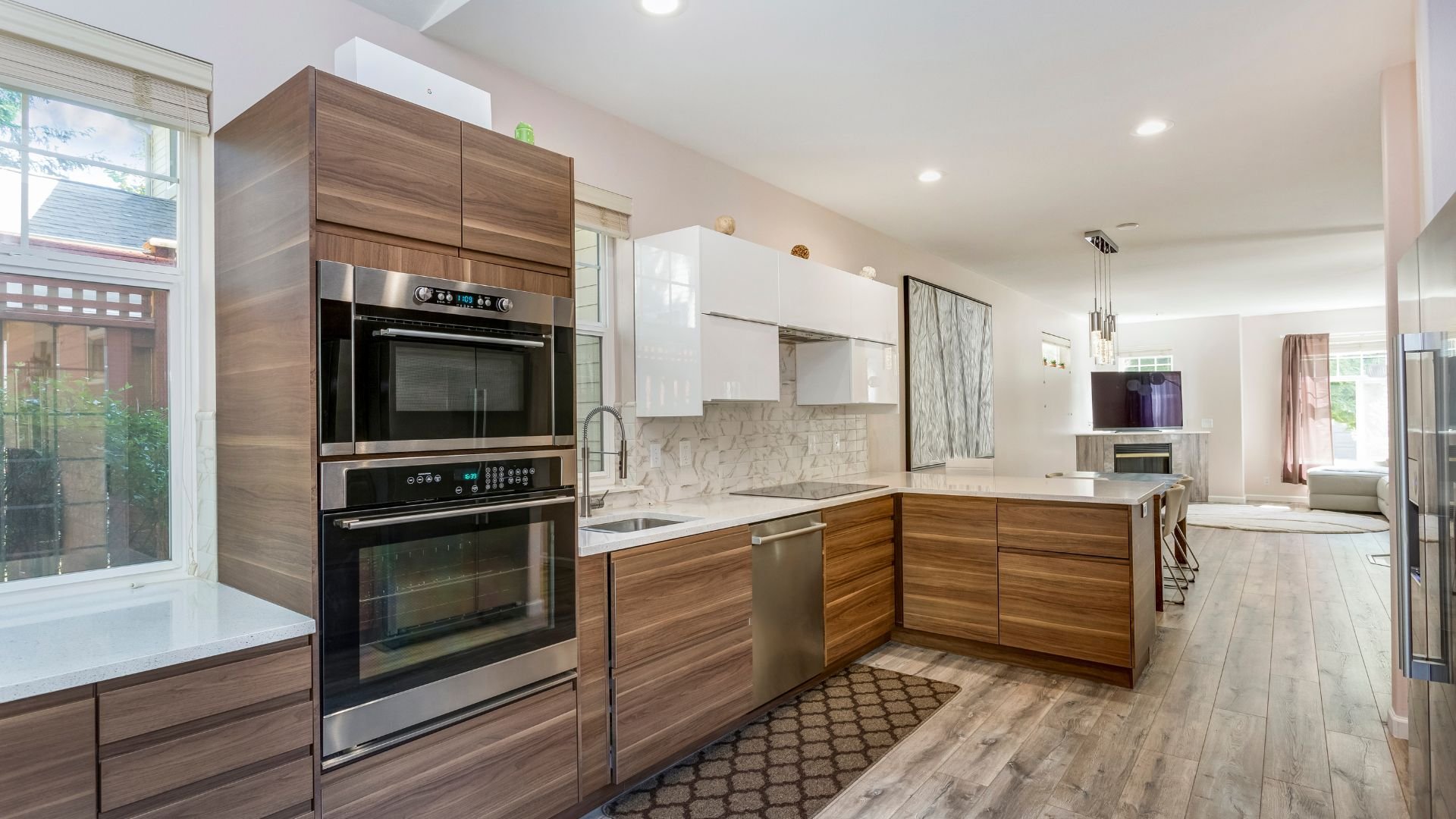 Modern kitchen with wooden cabinets, stainless steel appliances, and white countertops